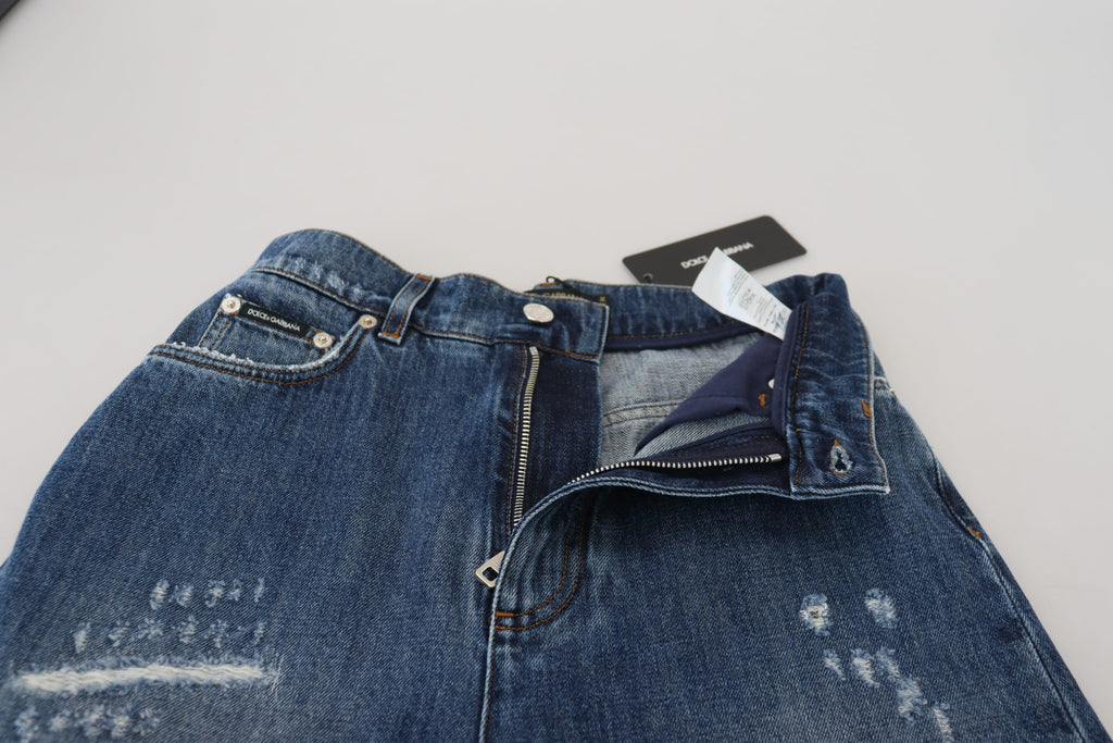Blå tvättade bomulls-trasiga denimjeans